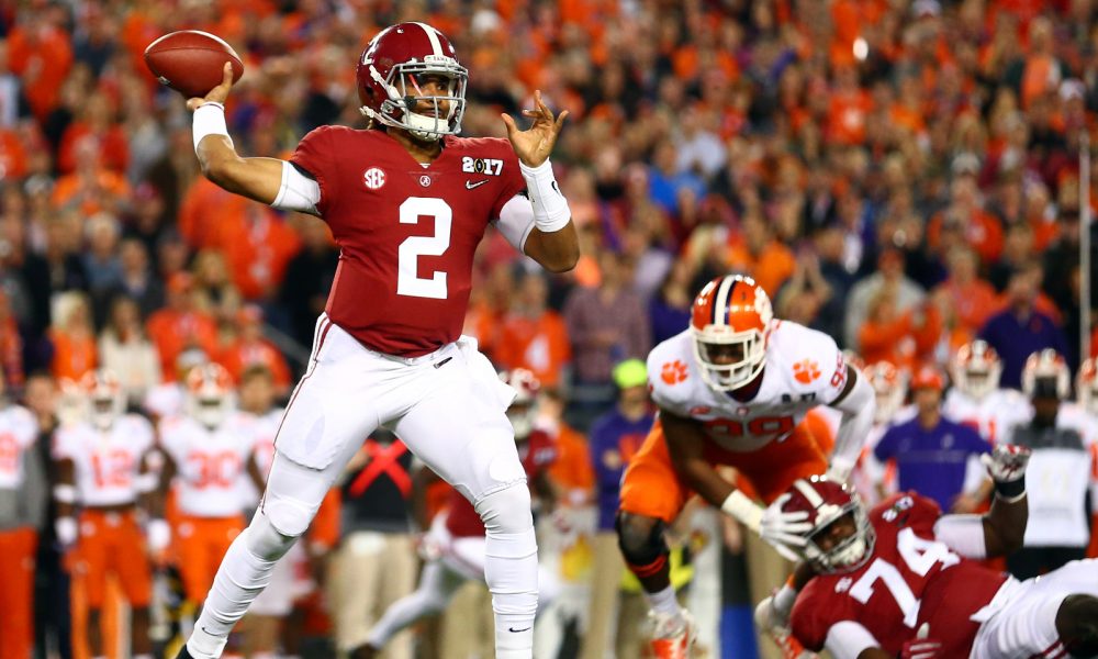 Alabama Crimson Tide quarterback Jalen Hurts (R) hugs defensive