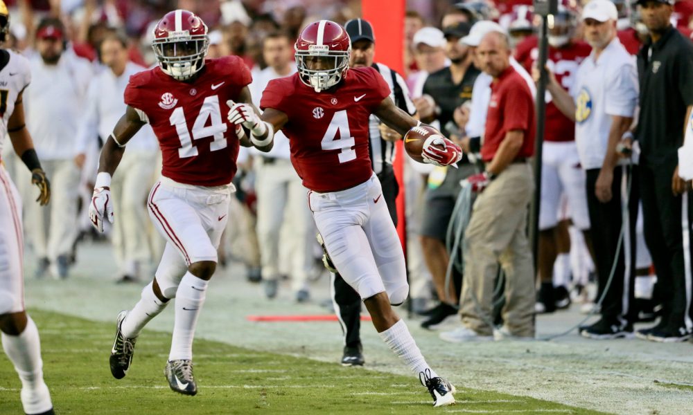 Saivion Smith (No. 4) returns an interception for a touchdown in 2018 for Alabama versus Arkansas State University