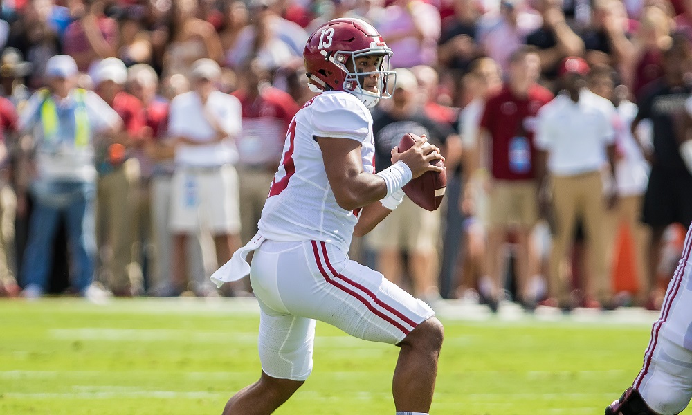 Alabama QB Tua Tagovailoa (#13) drops back to pass in 2019 matchup against South Carolina.