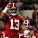 Tua Tagovailoa points one finger to the sky in celebration after scoring drive versus Tennessee in 2019