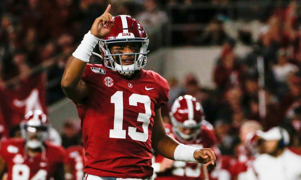 Tua Tagovailoa points one finger to the sky in celebration after scoring drive versus Tennessee in 2019