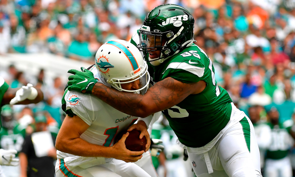 Quinnen Williams (#95) sacks Dolphins' QB Ryan Fitzpatrick in a 2019 matchup between Jets and Miami