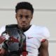 Dallas Turner poses for picture with Alabama belt during visit