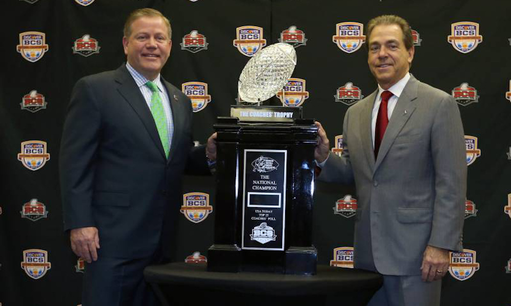 Nick Saban and Brian Kelly posing with the 2012 BCS National Championship Trophy