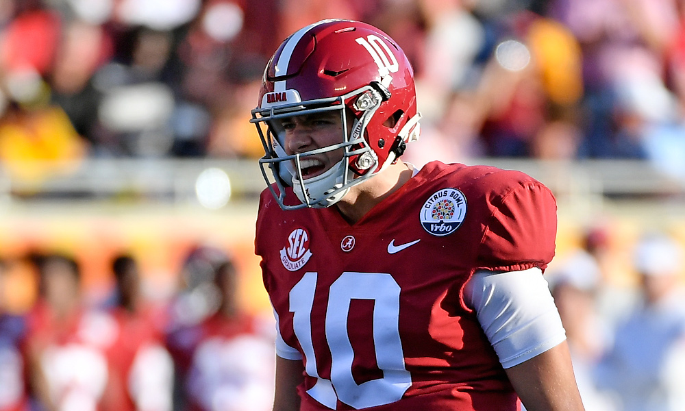 FILE - In this Jan. 1, 2020, file photo, Alabama quarterback Mac Jones (10)  rolls ut as he looks for a receiver during the first half of the Citrus  Bowl NCAA college