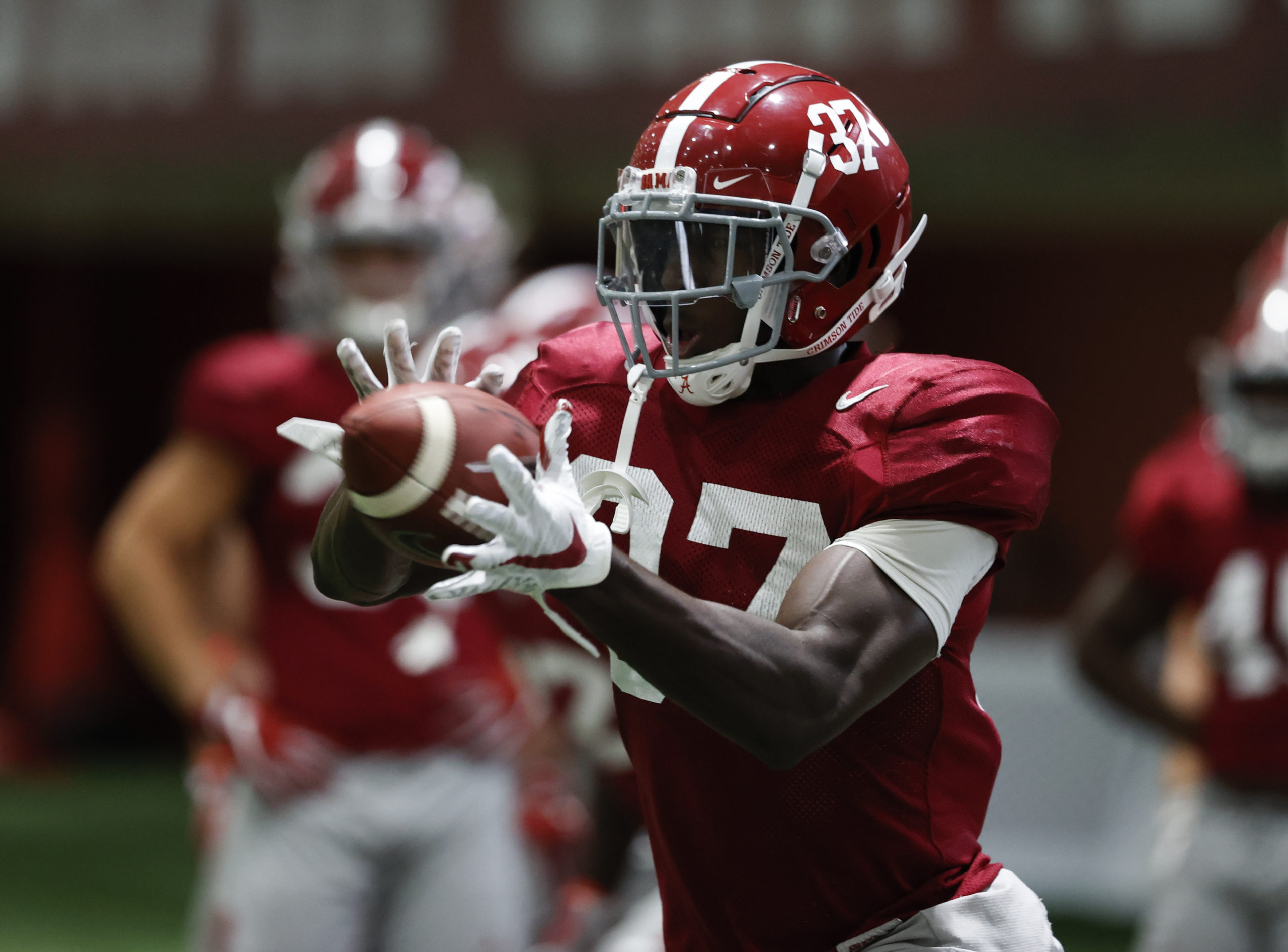 Demouy Kennedy catches football at Alabama practice