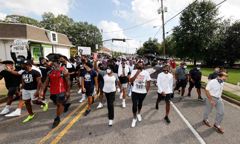 Alabama players and Nick Saban marching for racial equality