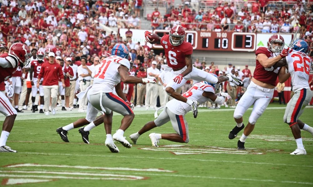 DeVonta Smith hurdles an Ole Miss defender