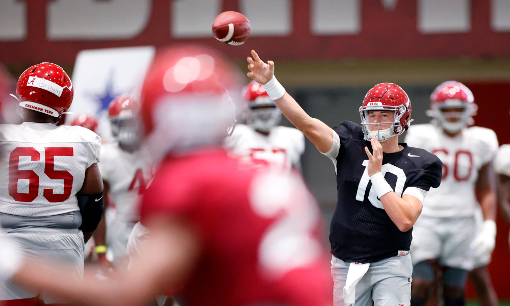 Mac Jones throws the ball indoors during an Alabama fall camp practice