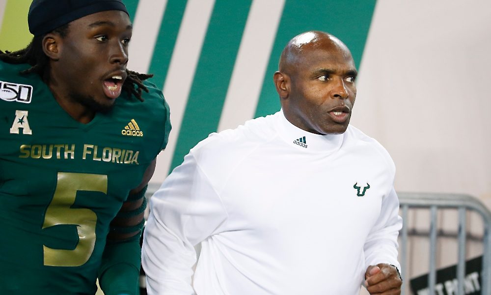 Charlie Strong leads USF out of the tunnel