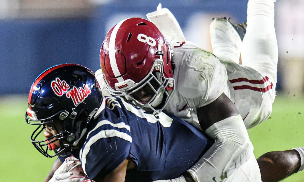 Christian Harris (No. 8) of Alabama tackles Jerrion Ealy of Ole Miss