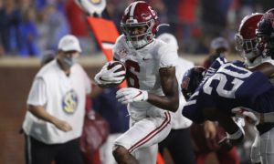 Alabama wr devonta smith carries the football against Ole Miss
