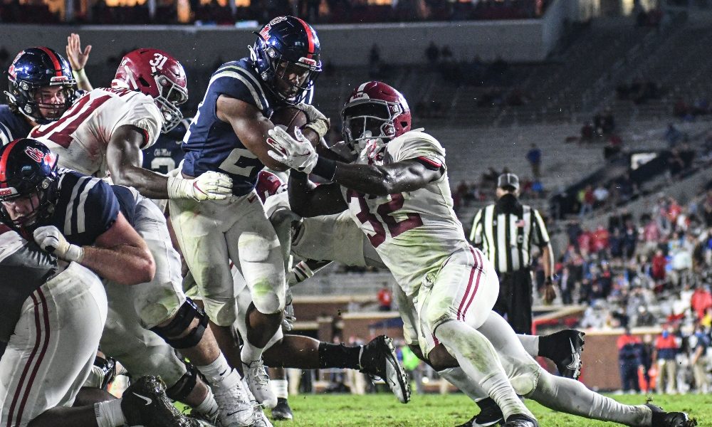 Dylan Moses tries to stop Ole Miss' running back on the goal line