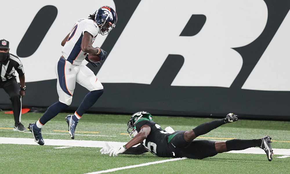 Jerry Jeudy (No. 10) of Denver Broncos breaks a tackle and scores versus New York Jets
