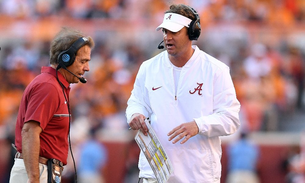 Lane Kiffin converses with Nick Saban on the sideline