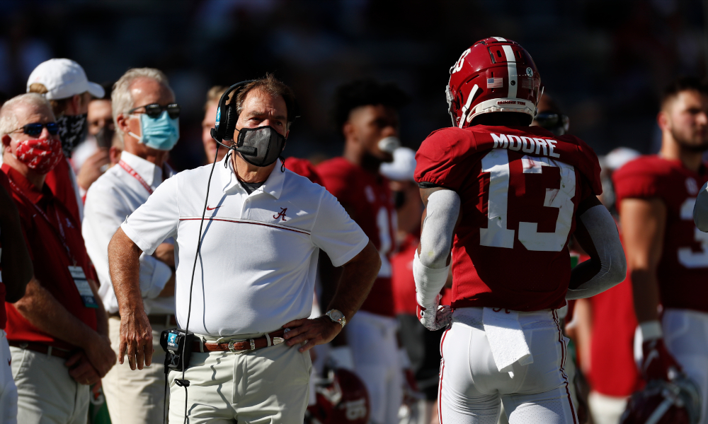 Nick Saban talking to Malachi Moore as he comes off the field