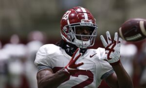 Alabama football running back Najee Harris catches a football at Tuesday practice