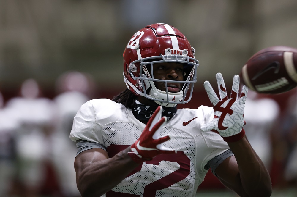 Alabama football running back Najee Harris catches a football at Tuesday practice