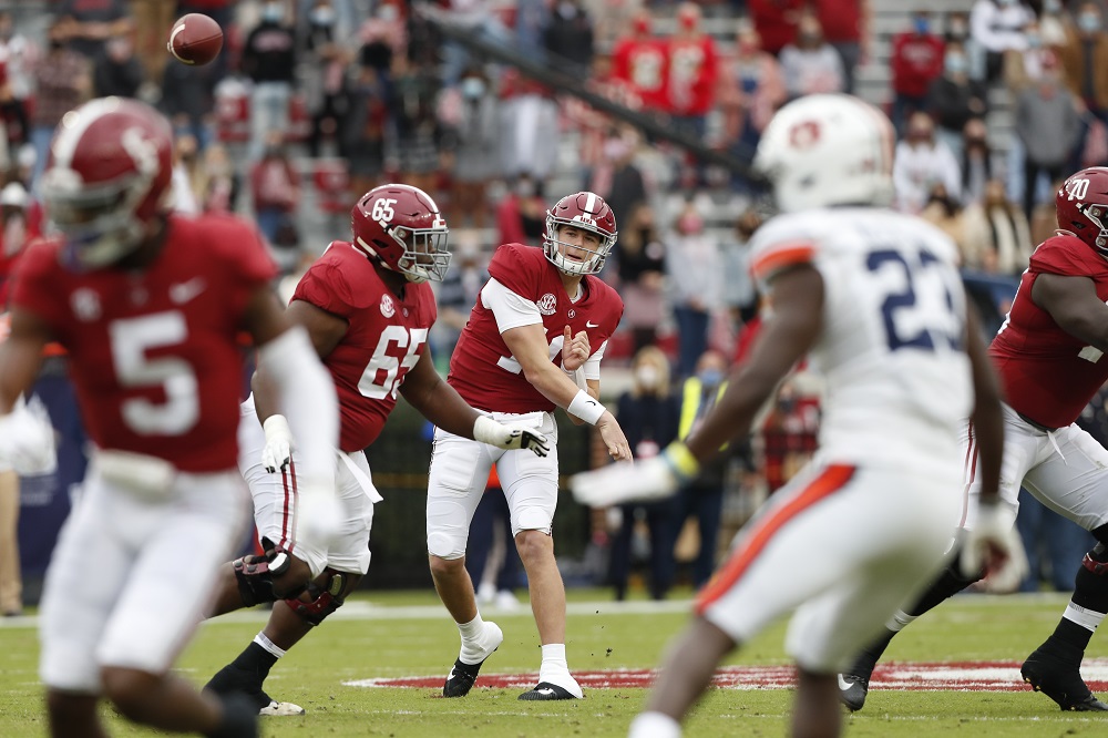 Mac Jones throws the football for Alabama as the Tide defeat Auburn in the 85th Iron Bowl