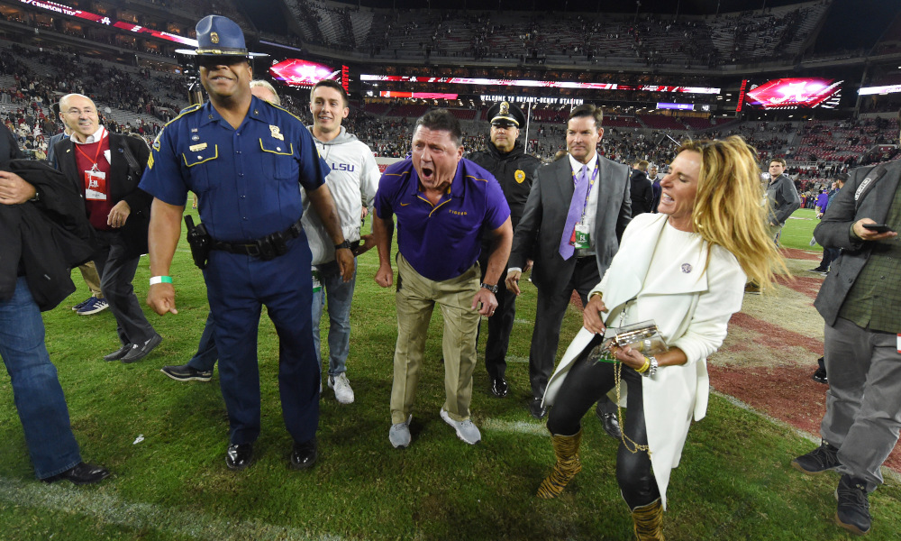 Ed Orgeron celebrates a win over Alabama at midfield in 2019 at Bryant-Denny Stadium