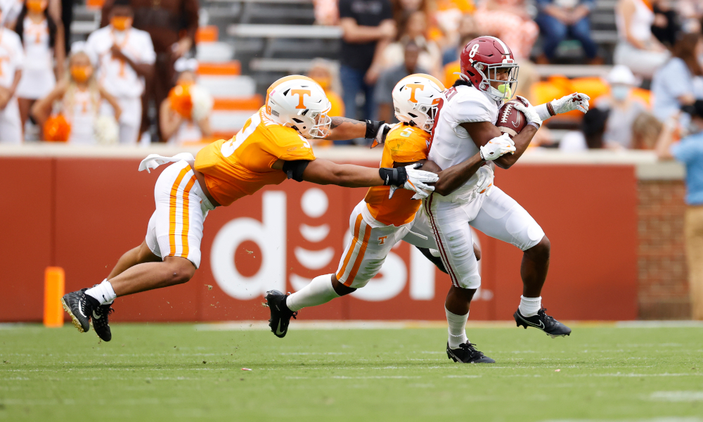 John Metchie (No. 8) of Alabama running through Tennessee defenders