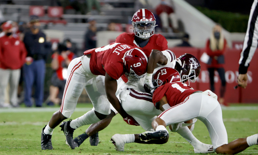 Malachi Moore (No. 13) of Alabama helps with tackling Miss. State RB