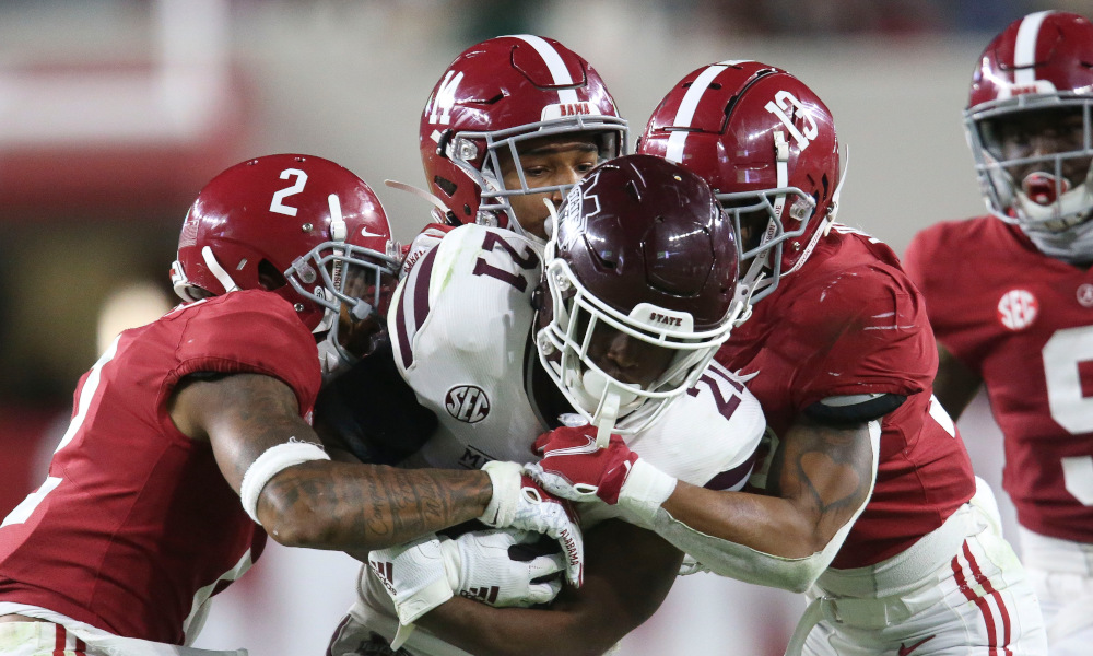 Malachi Moore (No. 13) helps Alabama DB's tackle RB Jo'quavious Marks of Miss. State