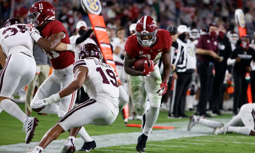 Trey Sanders lowers his shoulder against Mississippi State defender