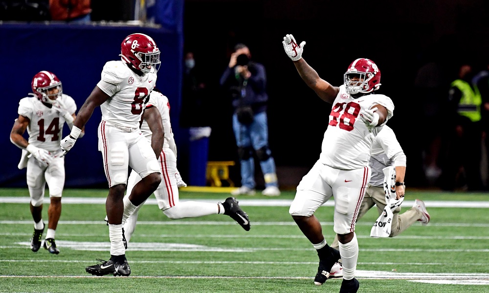 Alabama LB Christian Harris and Phidarian Mathis celebrate SEC Champiosnhip