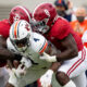 Christian Harris (No. 8) helps Dylan Moses (No. 32) tackle Tank Bigsby of Auburn