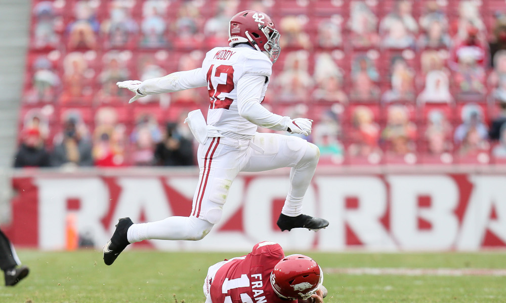 Jaylen Moody (No. 42) of Alabama jumps over Feleipe Franks of Arkansas