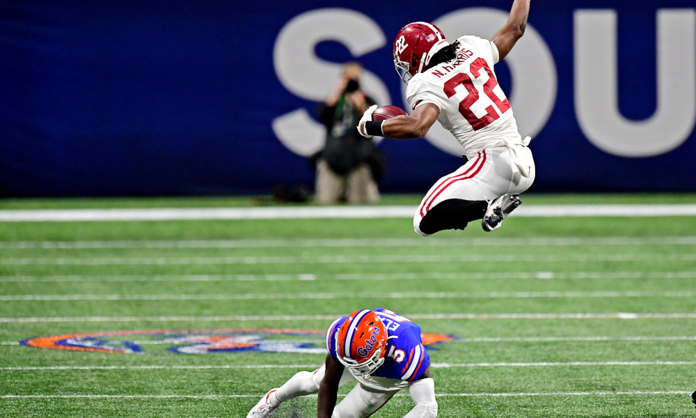 Najee Harris of Alabama hurdles Florida defender in SEC title game