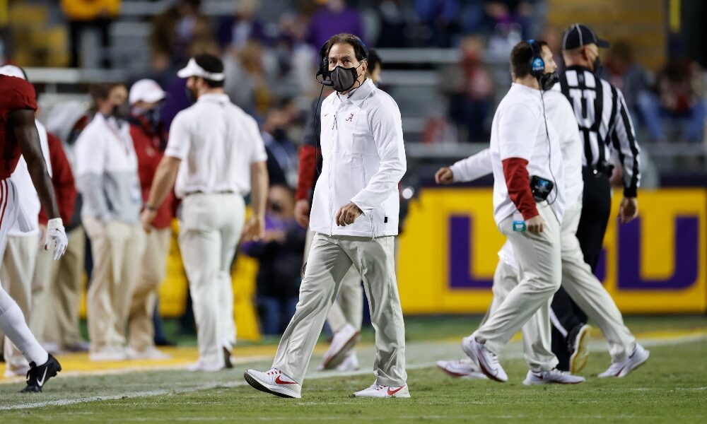 Nick Saban walks on the field at Tiger Stadium