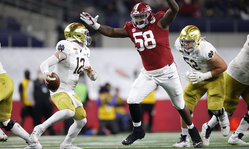Christian Barmore of Alabama pressure Notre Dame's Ian Book in the Rose Bowl