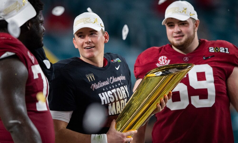 Mac Jones holds the CFP championship trophy