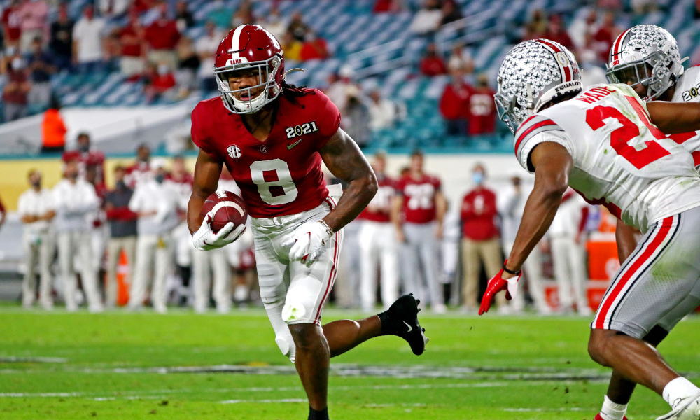 John Metchie runs with the ball against Shaun Wade of Ohio State in CFP title game