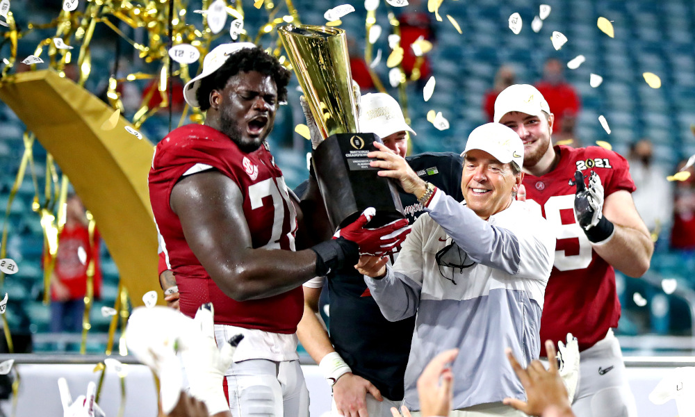 Nick Saban and Alex Leatherwood hold 2021 CFP National Championship trophy for Alabama