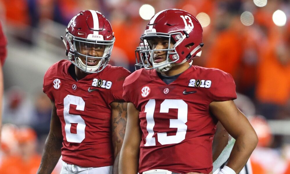 Tua Tagovailoa and DeVonta Smith talk before a play