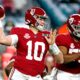 Mac jones throwing the football in crimson uniform