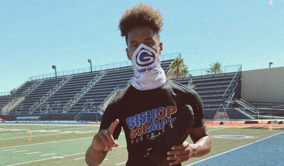 Cyrus Moss poses for picture in Bishop Gorman shirt