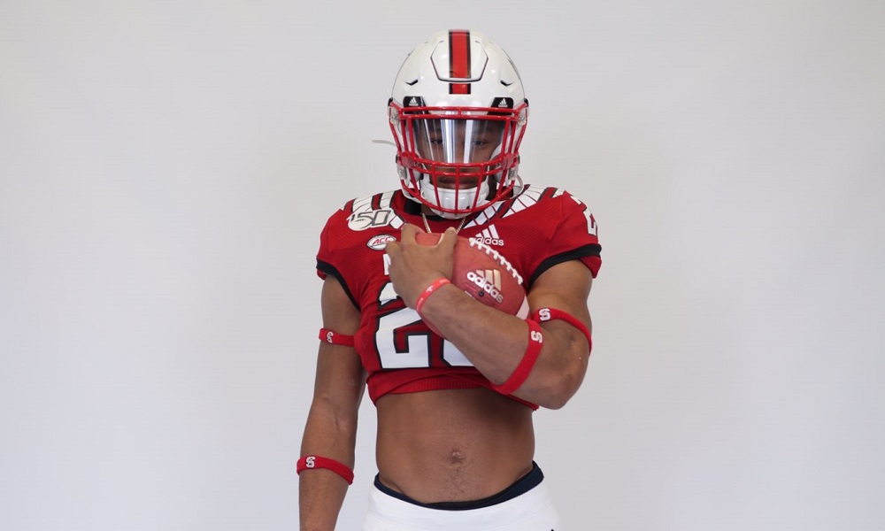 OMarion Hampton poses with football during visit