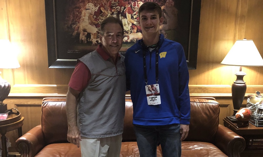 Ty Simpson takes a picture with nick Saban