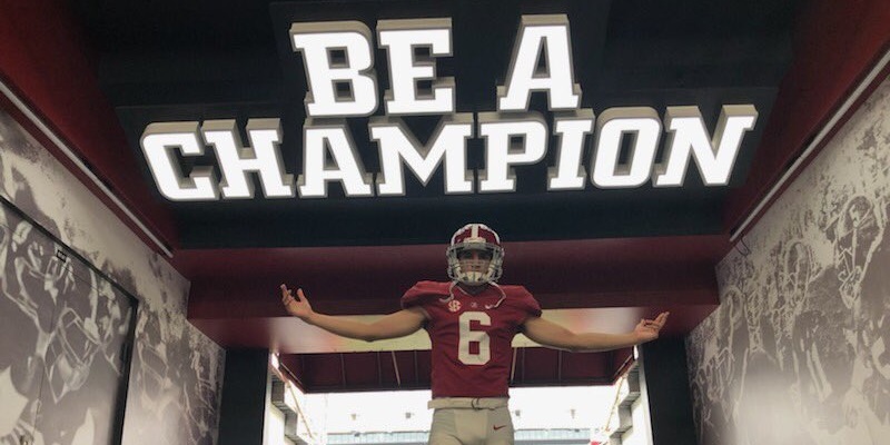 Ty Simpson takes picture in Bryant-Denny Stadium