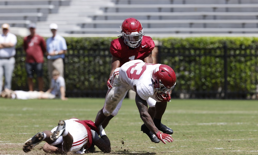 Roydell Williams (No. 23) runs the ball on Ga'Quincy McKinstry (No. 1) at Alabama's second scrimmage