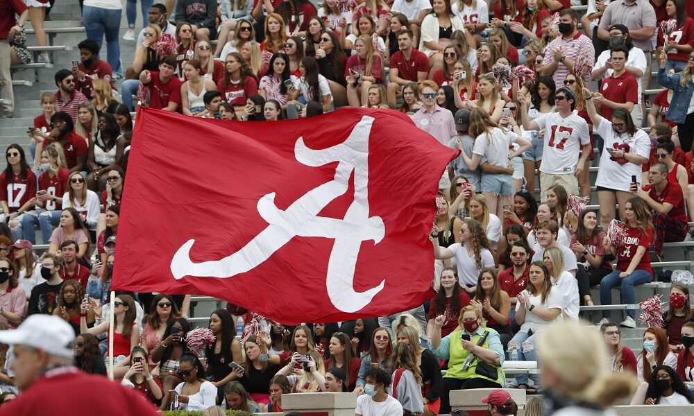 A flag is waved across the stands at Bryant-Denny Stadium