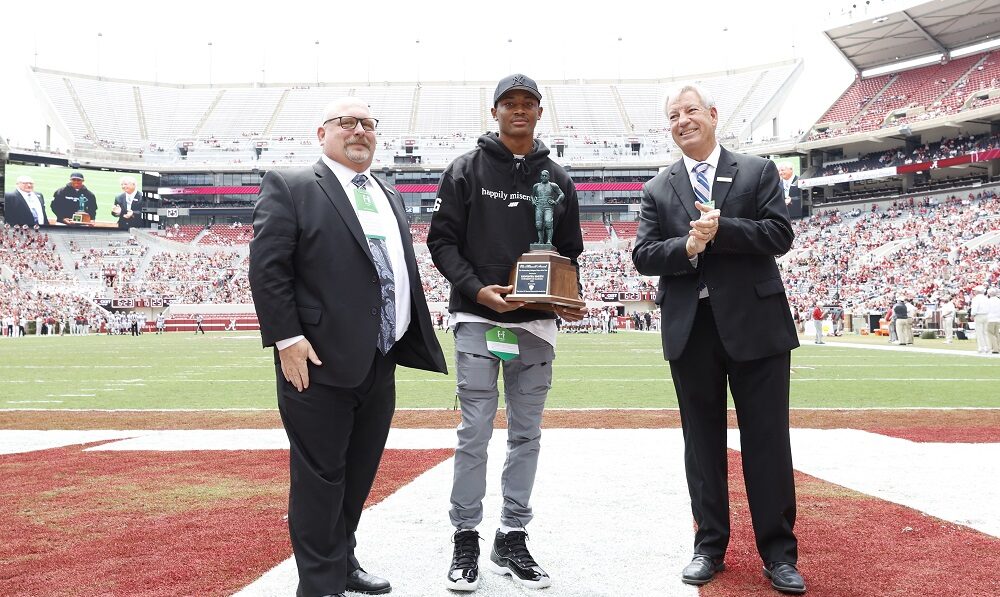 DeVonta Smith holding the Maxwell Award he won from 2020 season