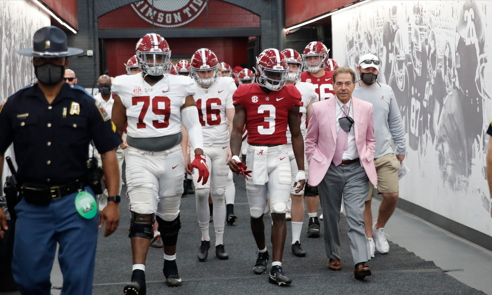 Nick Saban in his pink suit walking players out of tunnel for A-Day