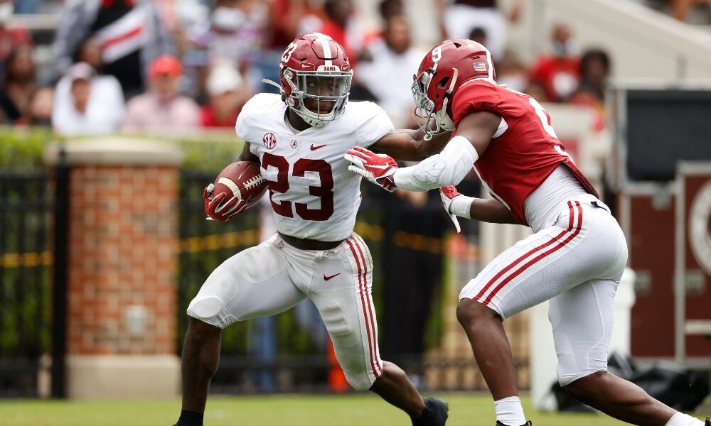 Roydell Williams stiff arms Jordan Battle during A-Day