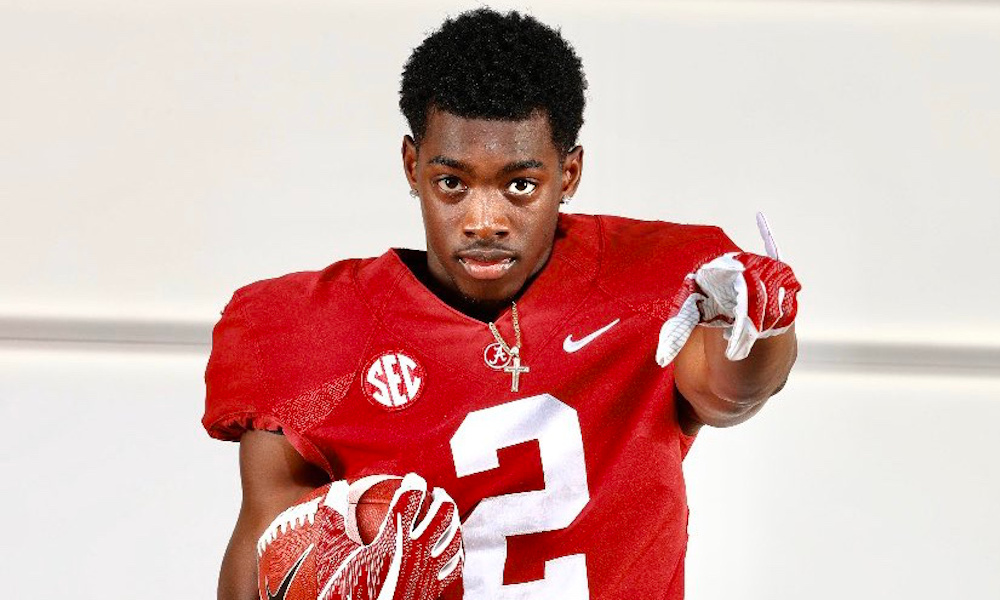 Terrion Arnold posing in his Alabama jersey during a visit