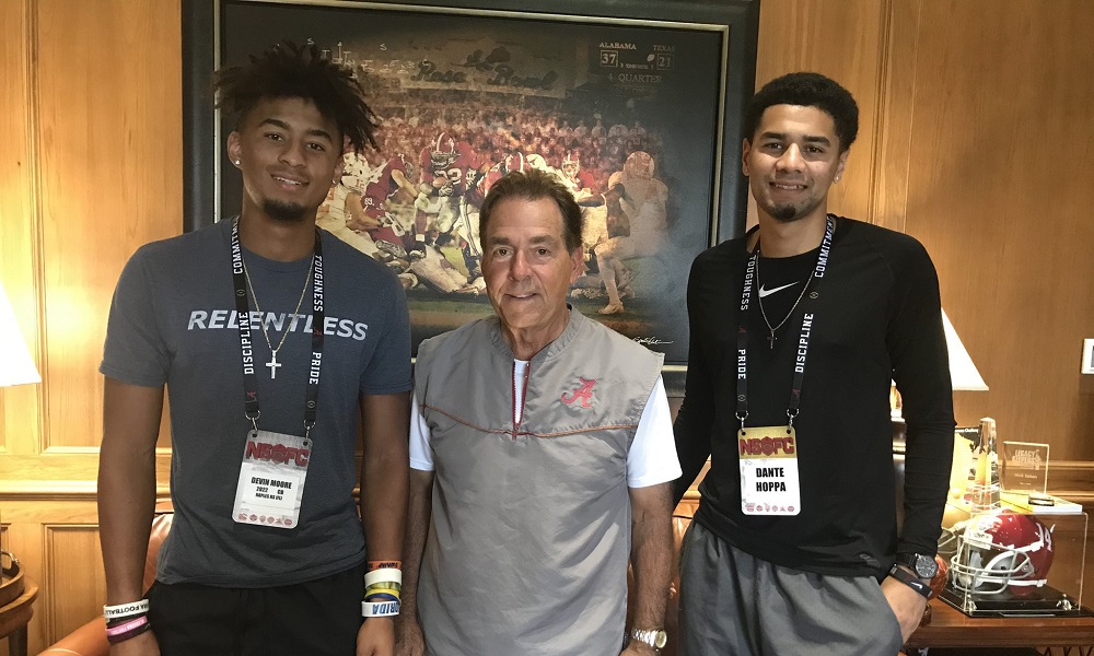 Devin Moore stands to the left of Nick Saban doing visit to Alabama